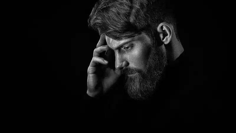 黑白相貌的年轻帅气的胡子男人图片素材-黑色背景上的胡子男人创意