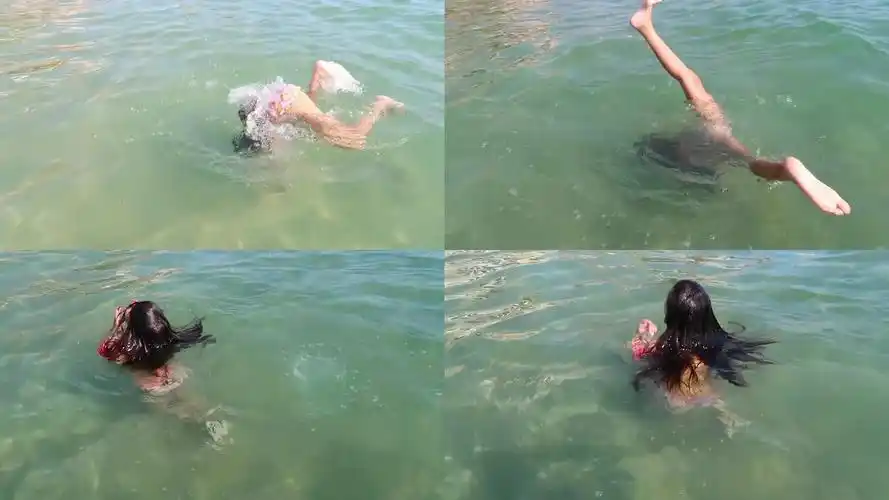 快乐的小女孩穿着泳衣在海滩上游泳