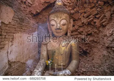 ancient buddha statue inside the ruined temple in