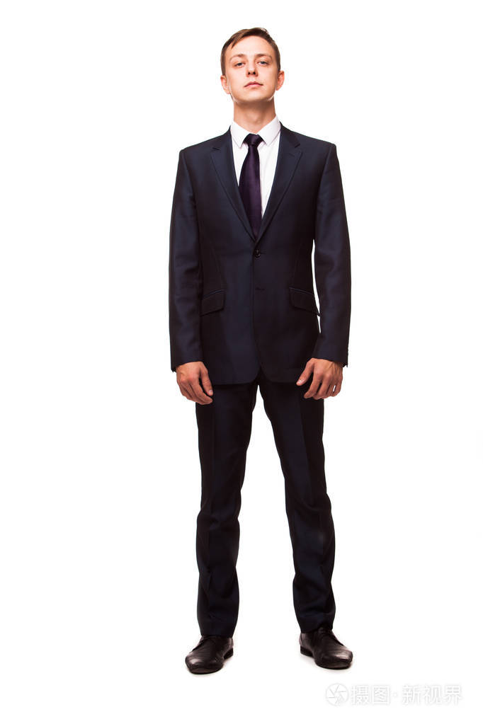 时尚的年轻男子在西装和领带经营作风英俊的男子站着相机的镜头