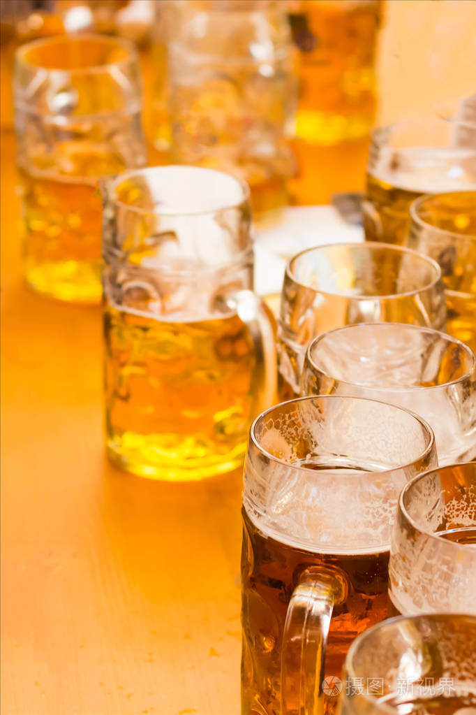 木制背景的桌子上有一杯啤酒垂直