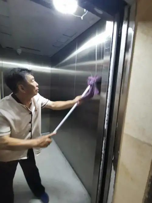 保洁员正在擦拭电梯轿厢