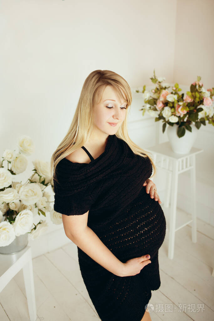 在工作室里大肚子的怀孕女孩
